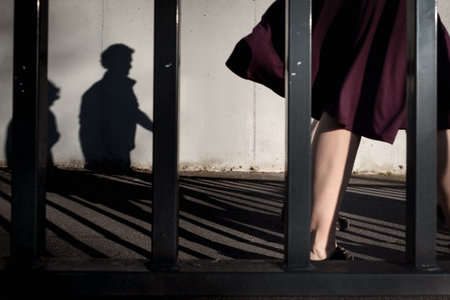Street photography of silhouette couple, bars, leg and purple dress
