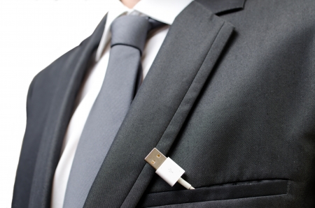 A businessman with a usb cable in his pocketの写真素材