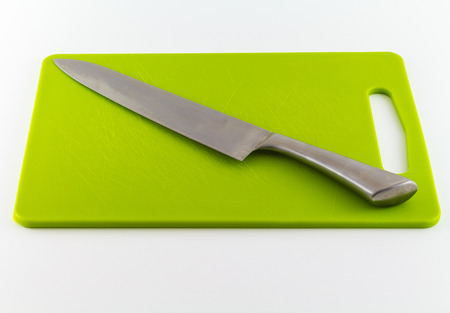 kitchen knife on cutting board isolated on white backgroundの写真素材