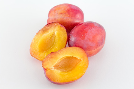 Fresh plums isolated on white backgroundの写真素材