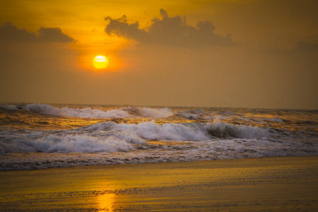 Sunset on the beach with waves crashing 2の写真素材