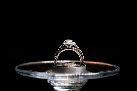 Wedding rings on a wine glassの写真素材
