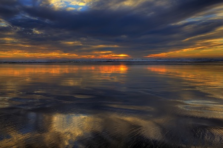 Sun setting on long beach washington during low tide