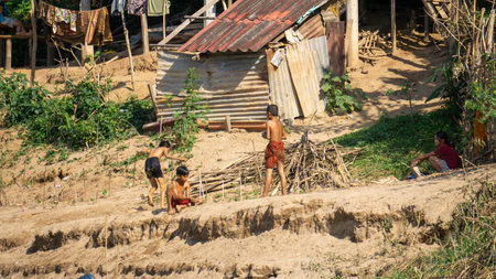 Kids playing on the shore of the mekong river in Luang Prabang, Laos.の写真素材