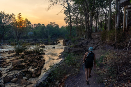 Guy walking near Tad Lo Waterfall on a bridge, near Pakse, Laos.の写真素材