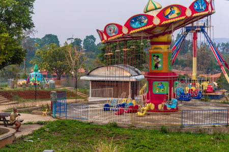 Colorful flying chairs in an abandoned amusement park, in the Pakse loop, Laos.の写真素材