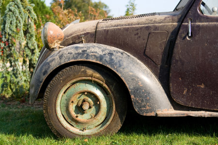 Old rusty car on the grass in the garden. Selective focus.の写真素材