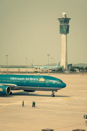 A Vietnam Airlines plane taxis along the runway, getting ready for takeoff のeditorial素材