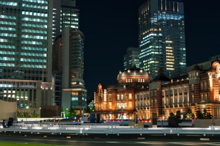 Tokyo Station at night, with the blurred motion of pedestrians and traffic.のeditorial素材