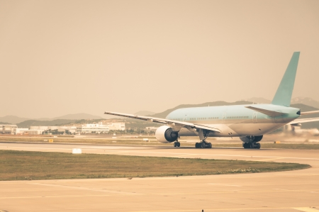 An airplane taxis along the runway, getting ready for takeoff の写真素材