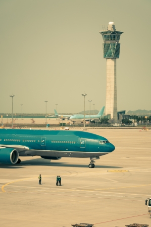 A plane taxis along the runway, getting ready for takeoff のeditorial素材