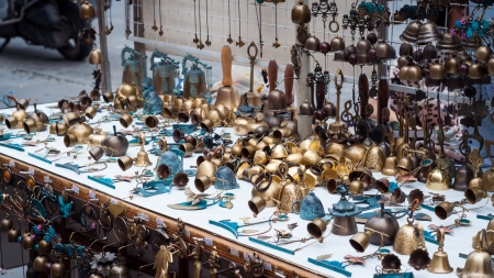 A vendor in Insadong, Seoul, sells little brass bells and other knick knacks.