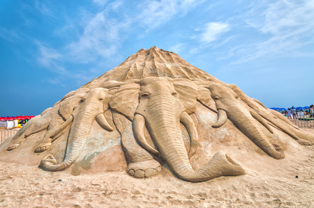 An group of elephants charge from a mountain of sand at the Busan Sand Festival in Busan, South...