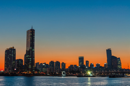 The sun sets behind the skyscrapers of Seoul, South Korea.の写真素材