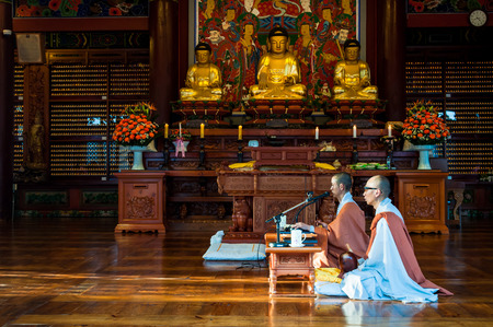 Two Buddhist monks chant prayers at Bongeunsa Temple on October 12, 2014 in Seoul, South Korea.のeditorial素材