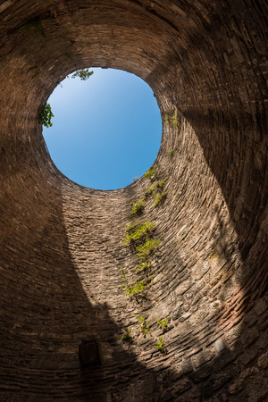 Looking up through a hole in the top of the old city walls in Istanbul, Turkey.の写真素材