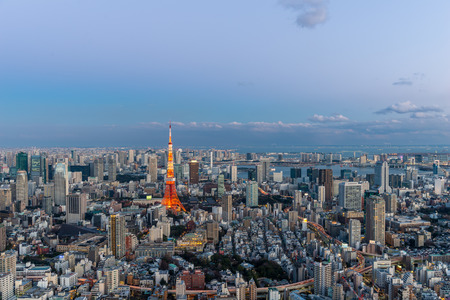 Tokyo Tower stands out among the Tokyo cityscape as dusk falls over Japan.のeditorial素材