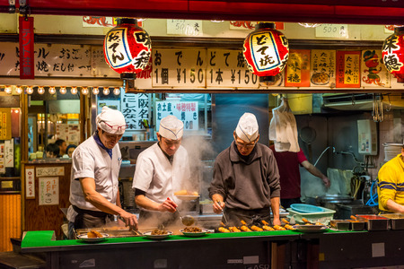 Men cook traditional Japanese street food on December 27, 2014 in Osaka, Japan.のeditorial素材