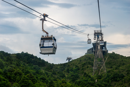 Cable cars rise up over the mountains of Lantau Island in Hong Kong, SAR.の写真素材