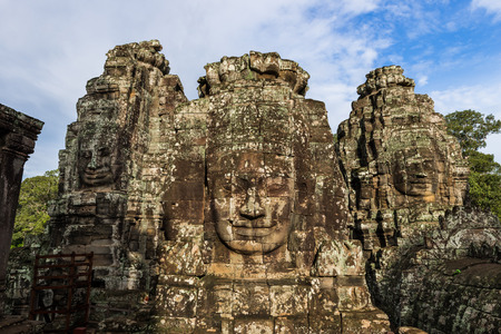 The ancient stone faces of the Bayon within the Angkor Thom temple complex in Siem Reap, Cambodia.の写真素材