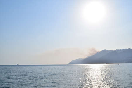sea landscape where the sun beats its rays on the waterの写真素材