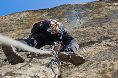 climber while climbing a vertical rock wallの写真素材