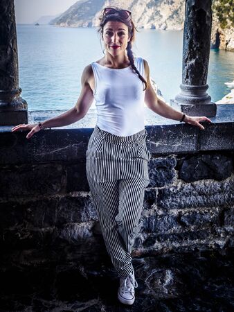 beautiful girl in the National park of Cinque Terre in Liguria, Italy, looking through the lens.の写真素材