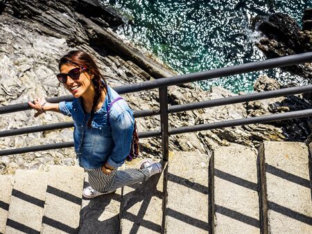 beautiful girl wolking in the National park of Cinque Terre in Liguria, Italy.の写真素材