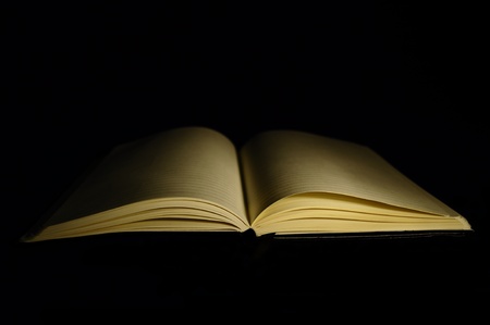blanc opened notebook in black backgroundの写真素材