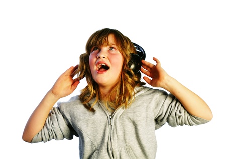 young girl listening to the music through headphones on white backgroundの写真素材