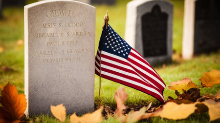 American flag and gravestone in cemetery with fallen leaves and copy space. AI Generatedの素材