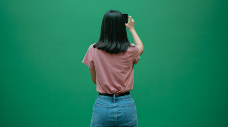 Casual Pink Against Vibrant Green Screen Backdropの素材