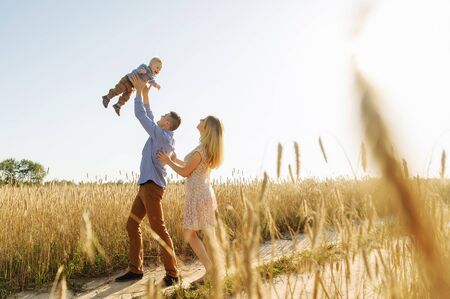 The moment of throwing the son up and catching him by the fatherの写真素材