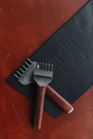 Two punches on the leather shred with the place for your text. Leather craft. Handmadeの写真素材