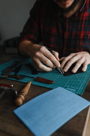 Man working with leather shred. Homemade. Craftの写真素材