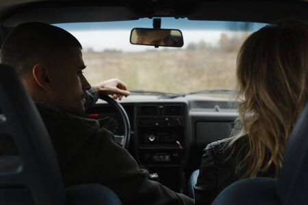 Man looking at his woman while sitting in the car. Love storyの写真素材
