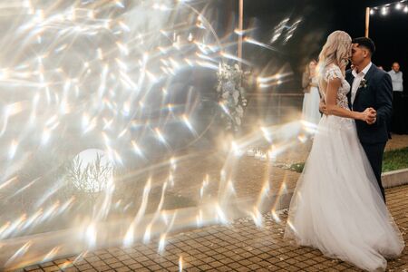 Beautiful bride and groom dancing together outside at the end of the wedding day. Newlywed portrait. Wedding photographyの写真素材