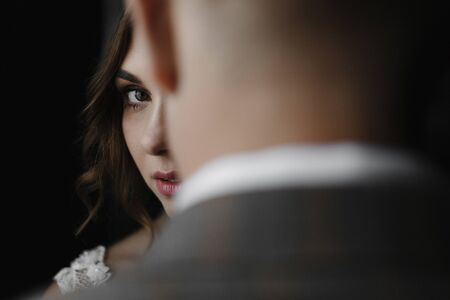 Bride looking over the groom. Bride and groom portrait. Wedding photoの写真素材