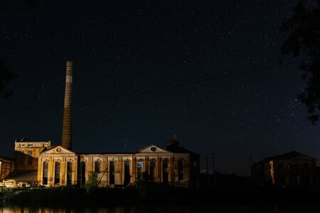 Old factory with high high pipe on the background of the starry night. Starry night. Stars in the nightの写真素材