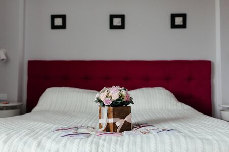 Roses bouquet in the wooden box on the white bad. Bouquet of flowers. Flowers. Floristic. High...