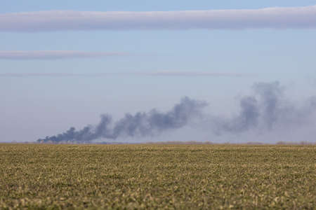 Panoramic view where black smoke can be seen in the distance. War in Ukraine