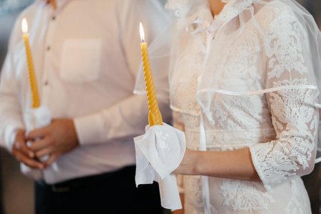Couple holding candles in church. Wedding ceremony