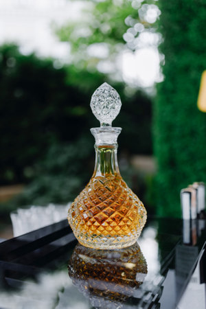 Crystal decanter with cognac isolated on green.の写真素材