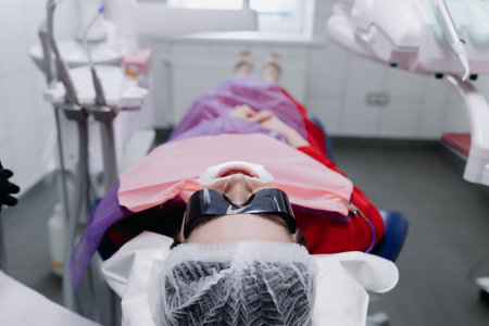 The patient is lying on a dental chair with glasses. Preparing to brush your teeth. High quality photoの写真素材