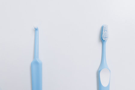 Two blue toothbrushes at different distances on a white backgroundの写真素材
