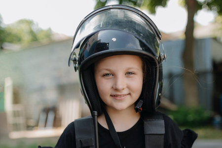 European child girl in police helmet. Police love children concept.の写真素材