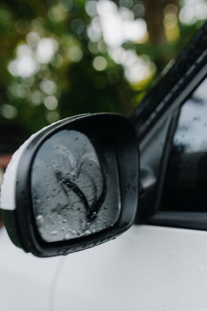 Side view of romantic heart pattern on fogged car side mirror. Vertycal photoの写真素材
