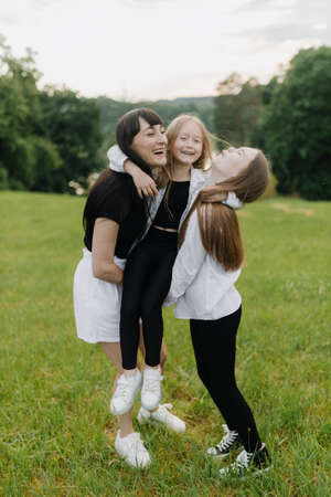 Mother and two daughters having fun in the park in summer. Happy family conceptの写真素材