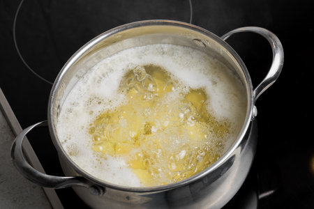 Potato wedges cooked in a pot on an induction stove. Cooking at homeの写真素材