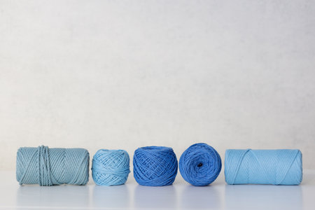 Cotton ropes and spools of various sizes for needlework and macrame in blue and blue colorsの写真素材